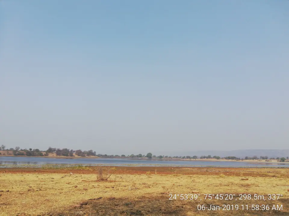 A wide shallow wetland with dry grassland in winter